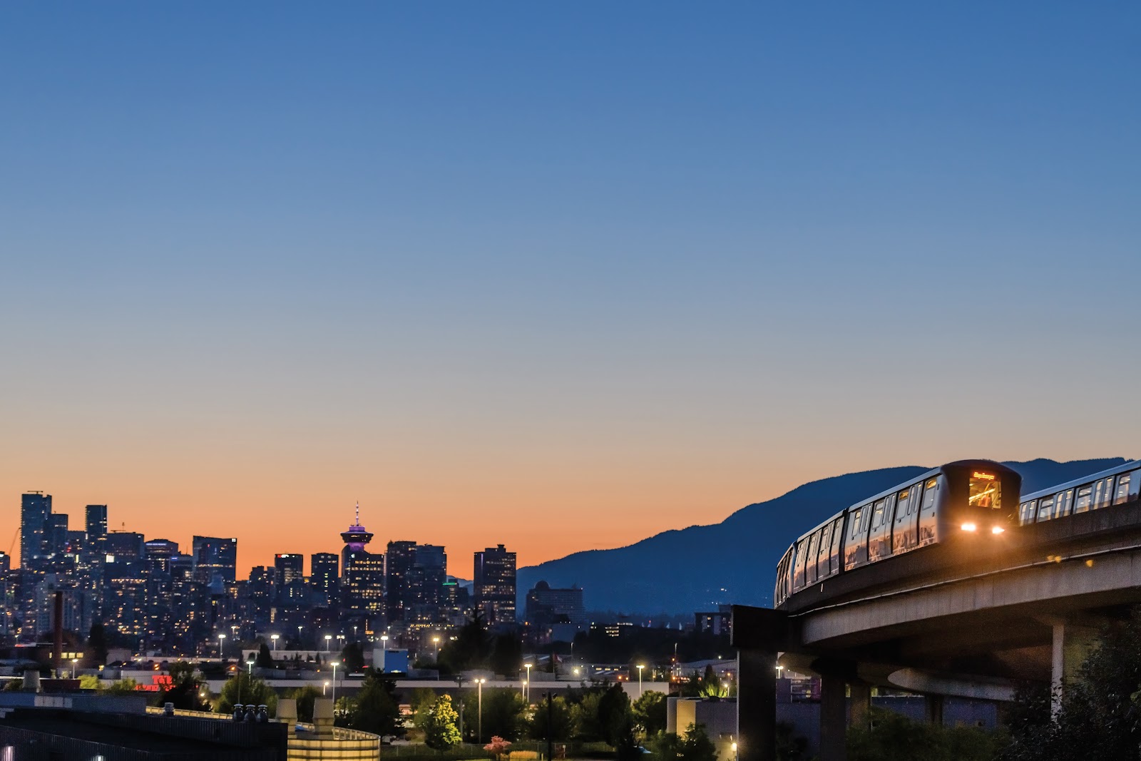 Vancouver skyline and SkyTrain at dusk